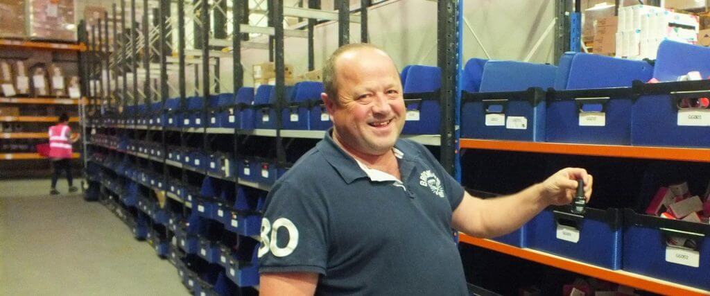 male warehouse worker, smiling